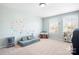 Bright playroom with neutral carpet, large windows, and a fun, colorful polka dot wall design at 3038 Burnello Ct, Iron Station, NC 28080