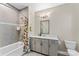 Well-lit bathroom featuring a shower-tub combination and large vanity at 318 N Dotger Ave, Charlotte, NC 28204
