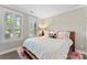 Cozy bedroom with large windows, plantation shutters, and neutral decor for a serene retreat at 318 N Dotger Ave, Charlotte, NC 28204