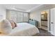 Bright bedroom features plantation shutters, fresh paint, and ensuite bathroom access at 318 N Dotger Ave, Charlotte, NC 28204