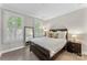 Cozy bedroom with large windows, white plantation shutters, and wood flooring at 318 N Dotger Ave, Charlotte, NC 28204