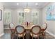 Elegant dining room featuring a wooden table, comfortable seating, and natural light streaming through shuttered windows at 318 N Dotger Ave, Charlotte, NC 28204