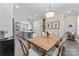 Charming dining area with a rustic wooden table, upholstered chairs, and easy access to the kitchen and other living areas at 318 N Dotger Ave, Charlotte, NC 28204
