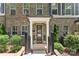 Inviting entryway with covered porch, decorative plants, and stylish black railings at 318 N Dotger Ave, Charlotte, NC 28204