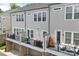 Back exterior of townhomes feature black metal railing decks with gray siding and garage entries at 318 N Dotger Ave, Charlotte, NC 28204