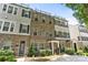 Brick townhome with black shutters and wrought-iron railings, offering a modern and stylish facade at 318 N Dotger Ave, Charlotte, NC 28204