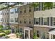 A row of modern townhomes features brick and siding, enhanced by manicured greenery at 318 N Dotger Ave, Charlotte, NC 28204