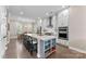 Modern kitchen featuring white cabinetry, stainless steel appliances, a large island with seating, and hardwood flooring at 318 N Dotger Ave, Charlotte, NC 28204