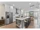Bright kitchen with stainless steel appliances, a central island with seating, and an open view to the living room at 318 N Dotger Ave, Charlotte, NC 28204