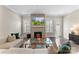 Stylish living room with a brick fireplace, modern furnishings, and hardwood floors at 318 N Dotger Ave, Charlotte, NC 28204