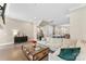 Spacious living room with hardwood floors, large sofa, and an open floor plan that leads into the kitchen area at 318 N Dotger Ave, Charlotte, NC 28204