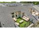Aerial view of a rooftop deck with artificial grass, neutral furniture, and access to the home at 318 N Dotger Ave, Charlotte, NC 28204