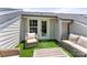 Relaxing rooftop deck featuring artificial grass and cozy furniture, accessible through a glass door with a window at 318 N Dotger Ave, Charlotte, NC 28204