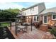 A beautiful brick backyard featuring an outdoor dining area and lounge area at 3604 Golfview Dr, Gastonia, NC 28056