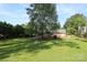 Expansive backyard with mature trees, a playset, and ample green space for outdoor activities at 3604 Golfview Dr, Gastonia, NC 28056