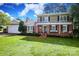 Charming brick home boasts a spacious front lawn, a second-story porch, and an inviting entrance for relaxing or entertaining at 3604 Golfview Dr, Gastonia, NC 28056