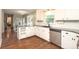 Bright kitchen with granite countertops, white cabinets, stainless steel dishwasher, and wood floors at 3604 Golfview Dr, Gastonia, NC 28056