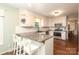 Bright kitchen featuring white cabinetry, granite counters, stainless appliances and breakfast bar for casual dining at 3604 Golfview Dr, Gastonia, NC 28056