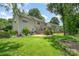 Spacious backyard featuring a well-maintained lawn, lush landscaping, and a cozy deck, perfect for outdoor living and entertaining at 3810 Yorkford Dr, Charlotte, NC 28269