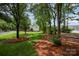 Large, private backyard with mature trees, offering ample space for outdoor enjoyment at 3810 Yorkford Dr, Charlotte, NC 28269