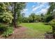 Expansive backyard with mature trees offering shade and privacy, perfect for relaxation at 3810 Yorkford Dr, Charlotte, NC 28269