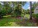 Lush backyard featuring mature trees, a small garden, and space for outdoor activities at 3810 Yorkford Dr, Charlotte, NC 28269