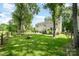 Expansive backyard with mature trees, inviting fire pit, and charming split rail fence creating a serene and private outdoor space at 3810 Yorkford Dr, Charlotte, NC 28269