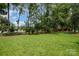 Expansive backyard featuring lush lawn, mature trees, and ample space for outdoor activities at 3810 Yorkford Dr, Charlotte, NC 28269
