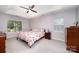 Relaxing bedroom featuring a ceiling fan, floral bedding, and bedside tables with lamps at 3810 Yorkford Dr, Charlotte, NC 28269