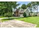 A brick and vinyl home with a well-maintained lawn and concrete driveway at 3810 Yorkford Dr, Charlotte, NC 28269