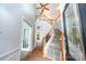 Bright foyer featuring wood floors, a staircase, and modern lighting fixtures at 3810 Yorkford Dr, Charlotte, NC 28269