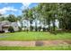 Expansive front yard with lush lawn and mature trees, enhancing curb appeal at 3810 Yorkford Dr, Charlotte, NC 28269