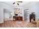 Home office featuring wood floors, a ceiling fan and a staircase visible in the background at 3810 Yorkford Dr, Charlotte, NC 28269