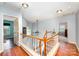 View of a stairway featuring wood handrails and white spindles with an open landing at 3810 Yorkford Dr, Charlotte, NC 28269