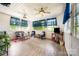 Inviting sunroom featuring ceiling fans, bright windows, and comfortable seating at 3810 Yorkford Dr, Charlotte, NC 28269