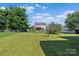 Spacious backyard with green grass, privacy fence, and covered patio - ideal for entertaining at 4111 Alexis Sw Ct, Concord, NC 28027