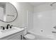 Clean bathroom featuring a vanity, a round mirror, and a shower and tub combo at 4111 Alexis Sw Ct, Concord, NC 28027