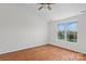 Bright bedroom features hardwood floors, neutral walls, and large windows with backyard view at 4111 Alexis Sw Ct, Concord, NC 28027