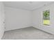 Bedroom featuring soft gray carpet, neutral walls, and natural light from the large window at 4111 Alexis Sw Ct, Concord, NC 28027