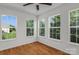An empty room with hardwood floors and multiple bright windows at 4111 Alexis Sw Ct, Concord, NC 28027