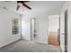 Bright bedroom with a ceiling fan, neutral paint, carpet, and convenient access to an ensuite bathroom at 4111 Alexis Sw Ct, Concord, NC 28027