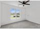 Bedroom with neutral walls, gray carpet, and a window providing natural light at 4111 Alexis Sw Ct, Concord, NC 28027