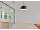 Bright dining area with sliding glass doors and stylish light fixture at 4111 Alexis Sw Ct, Concord, NC 28027
