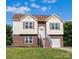 Charming two-story home boasts a brick facade, light siding, and lovely landscaping at 4111 Alexis Sw Ct, Concord, NC 28027