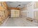 Unfinished garage with an insulated wall, concrete floors, and a garage door at 4111 Alexis Sw Ct, Concord, NC 28027