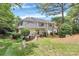 View of the townhouse backyard surrounded by lush greenery and tall trees at 4263 Melrose Club Dr, Matthews, NC 28105