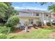 View of the townhouse backyard surrounded by lush greenery and AC unit at 4263 Melrose Club Dr, Matthews, NC 28105