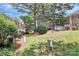 Backyard landscape showcasing green space and mature trees between townhome residences at 4263 Melrose Club Dr, Matthews, NC 28105