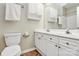 Bright bathroom featuring double sinks, white cabinets, and updated fixtures at 4263 Melrose Club Dr, Matthews, NC 28105