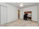 Comfortable bedroom includes a ceiling fan, study area, and closet at 4263 Melrose Club Dr, Matthews, NC 28105